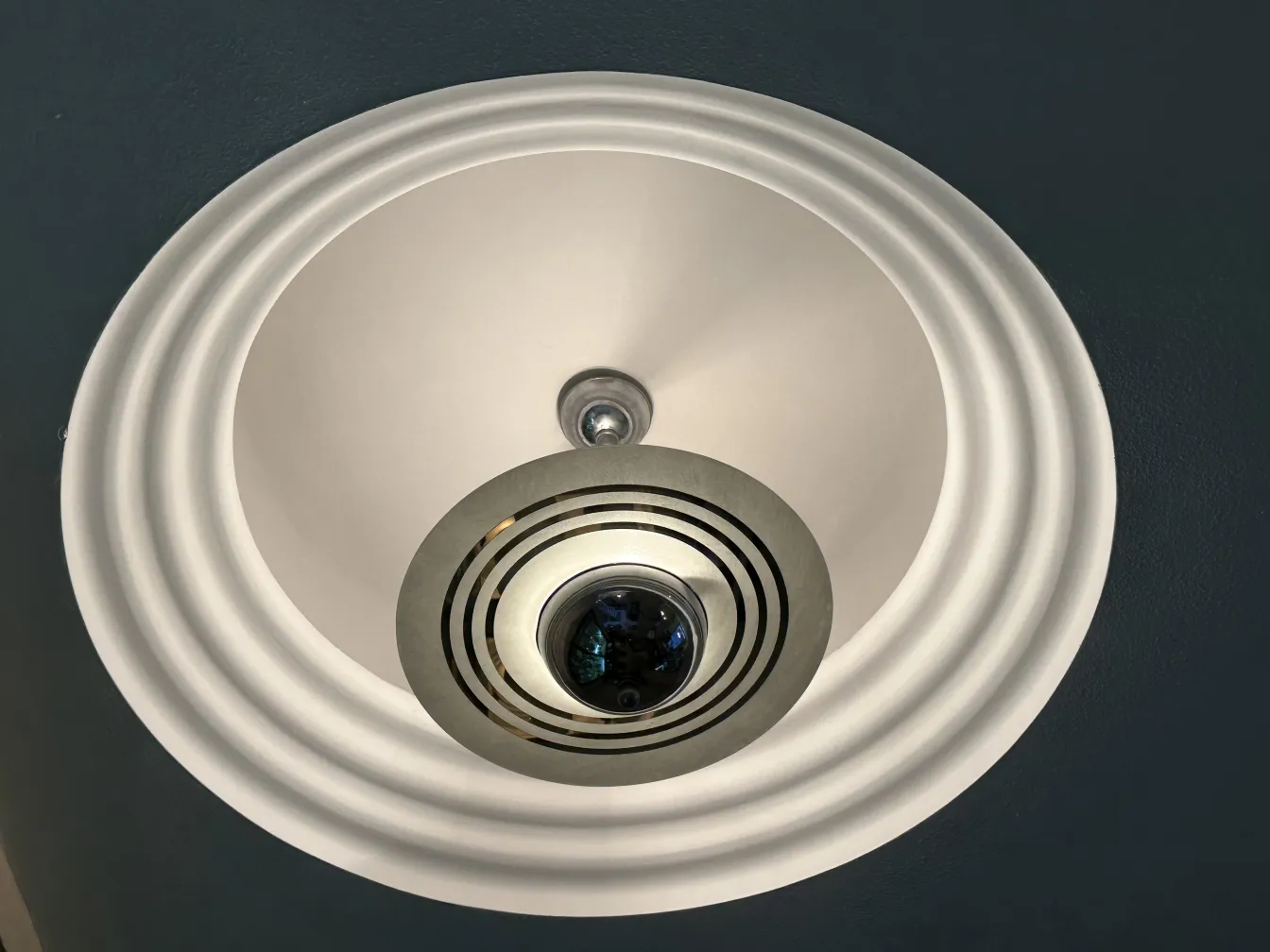 Antique hanging lamp with striped design details, illuminating the space.