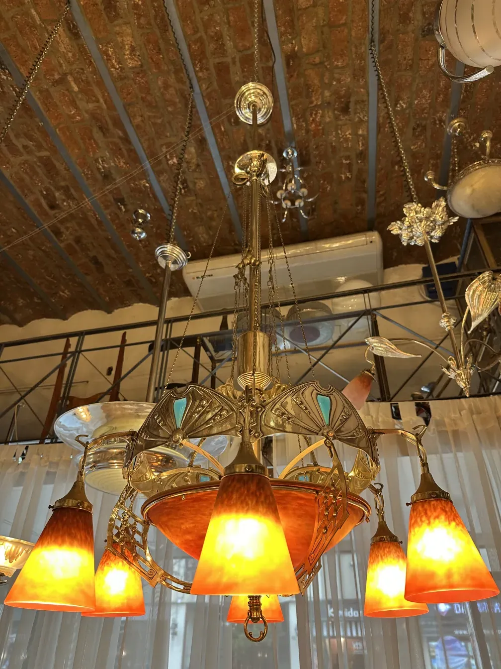 antique hanging lamp with bright orange lights and decorative details