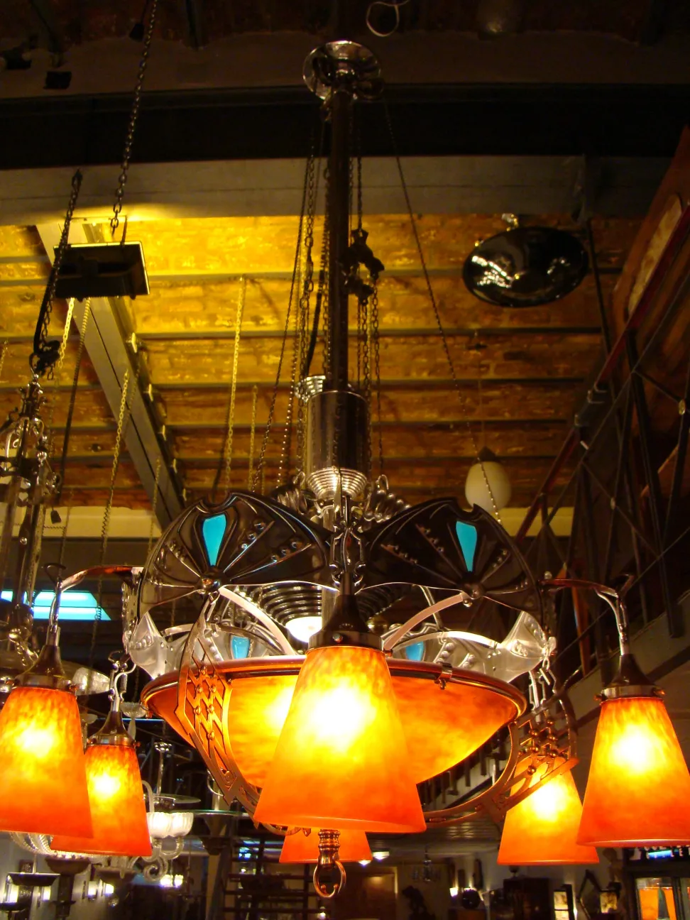 antique hanging lamp by Charles Schneider with orange shades in a stylish illuminated setting