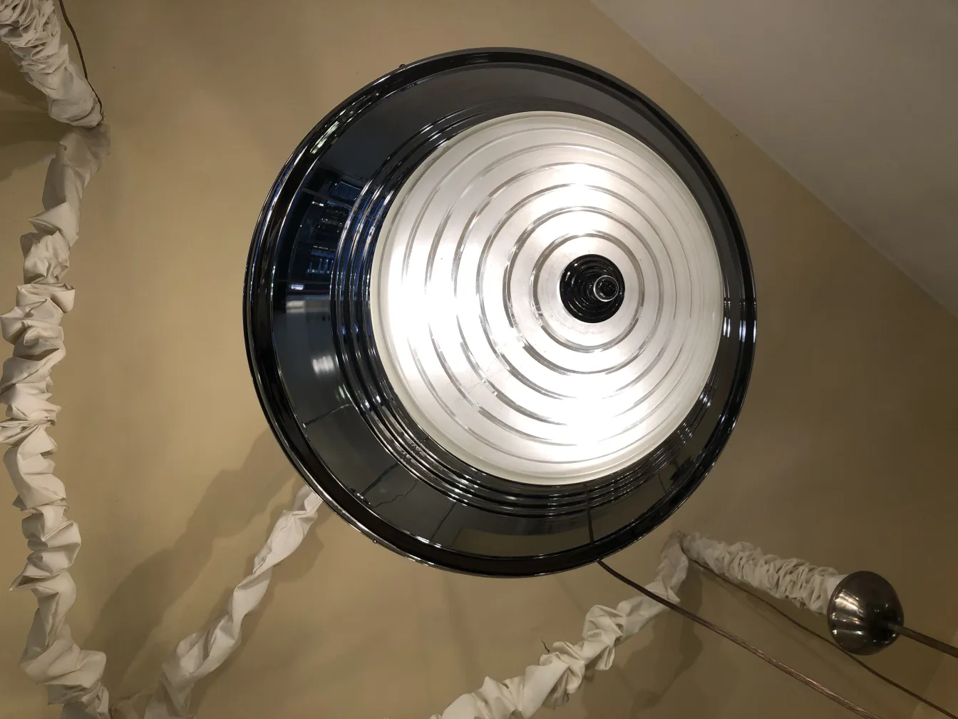 Lámpara de techo antigua con detalles únicos y luces brillantes, ambientada en una habitación elegante.