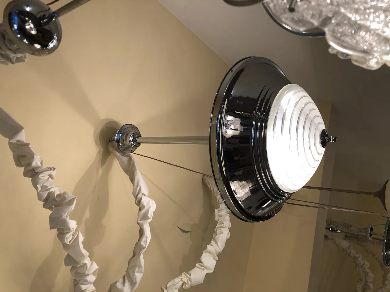 Antique hanging lamp with a glossy design, set in a neutral environment.