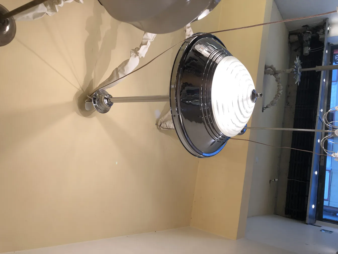 Antique hanging lamp with bright light in a light environment.