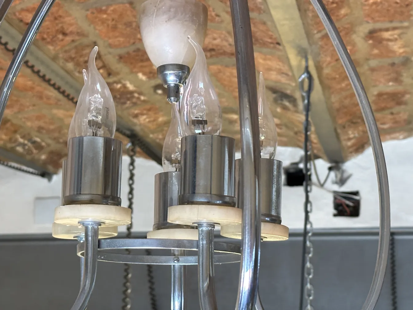 antique hanging lamp with multiple lit bulbs, elegant design.