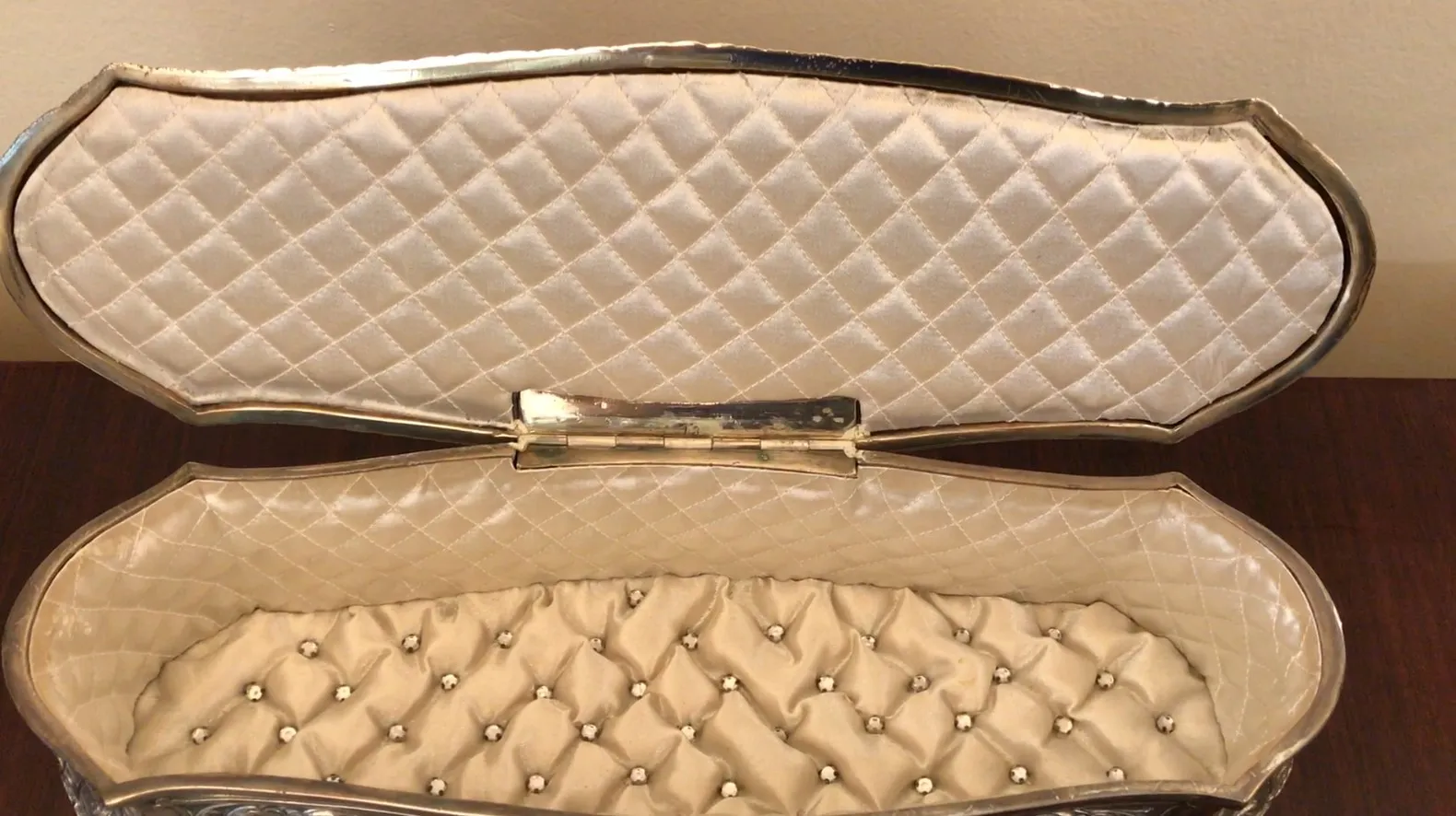 Antique jewelry box with an elegant design and soft lining.