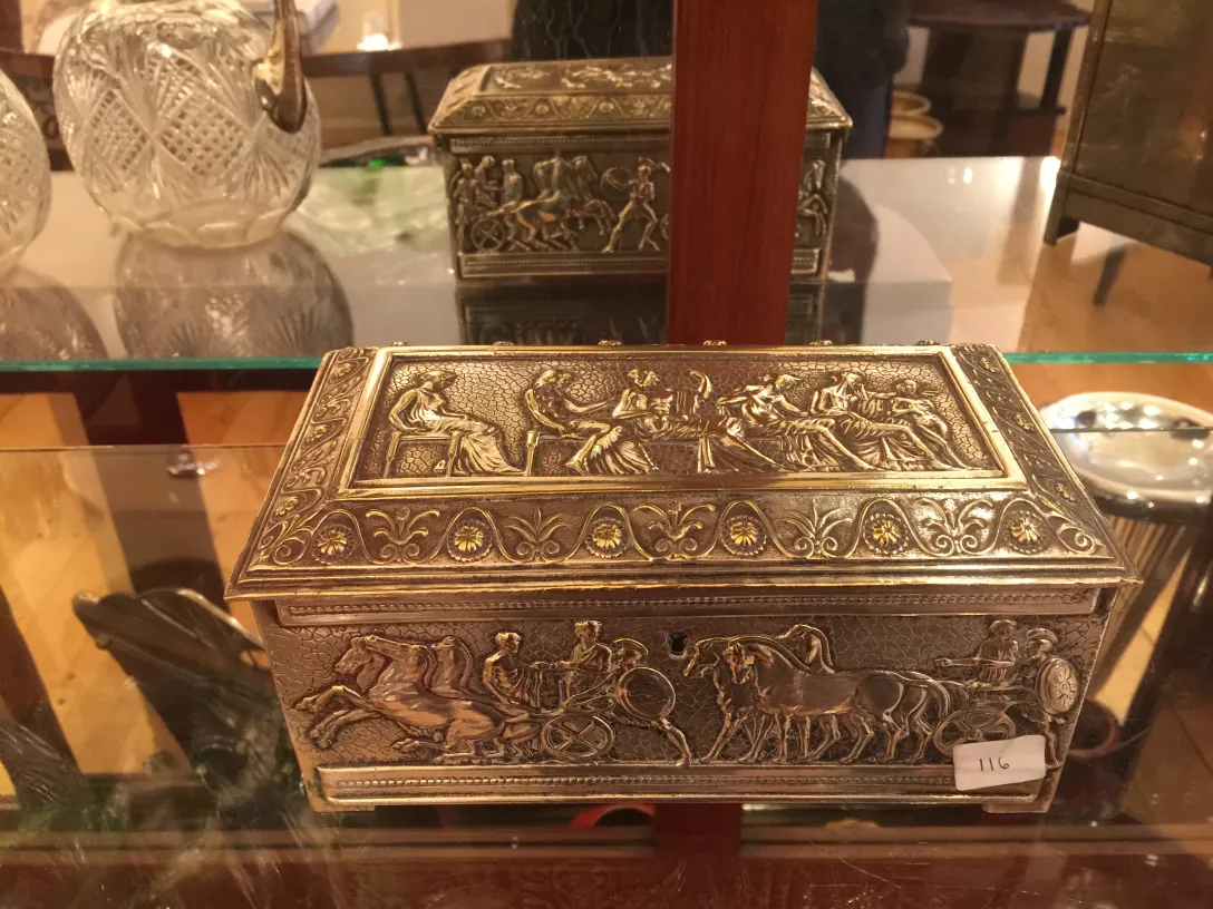Antique box adorned with artistic reliefs and figures