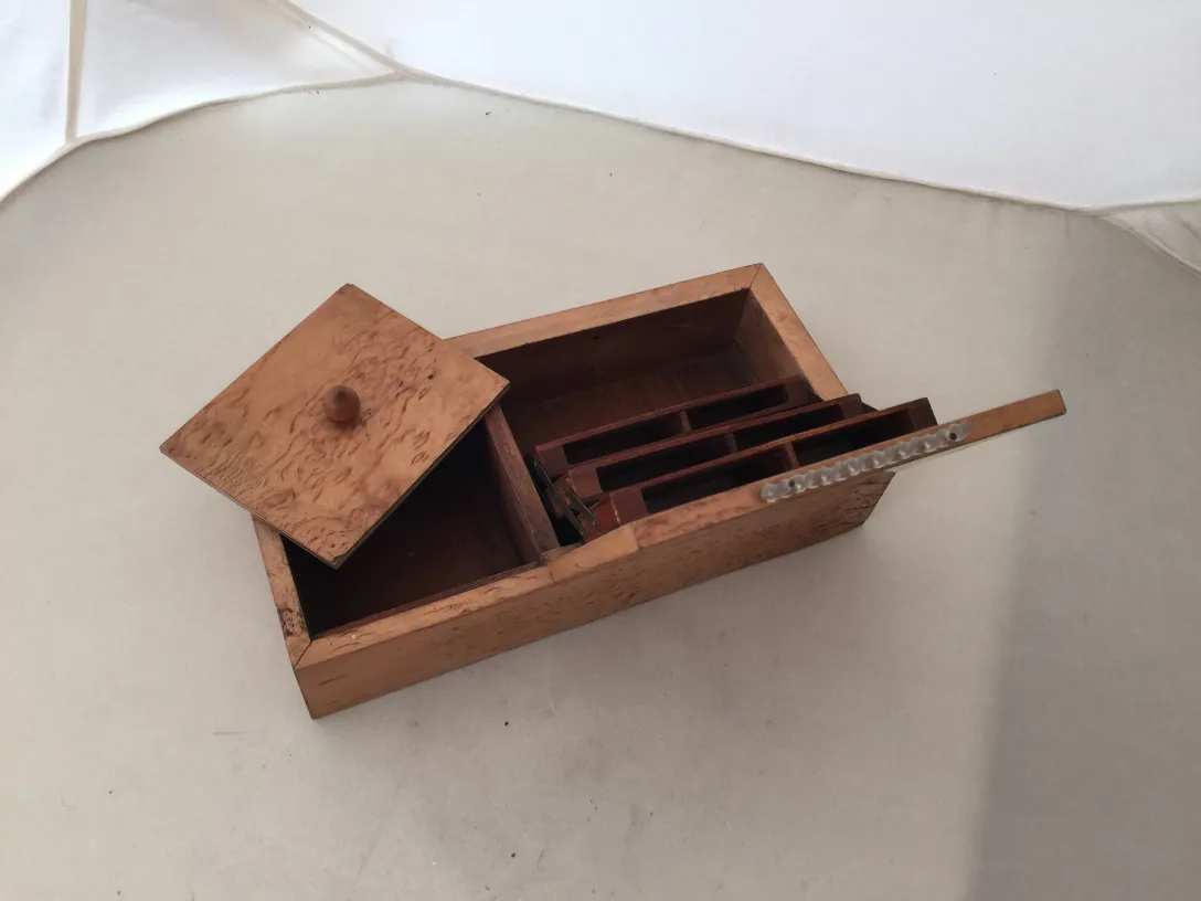 Antique wooden box with a lid and internal compartments.