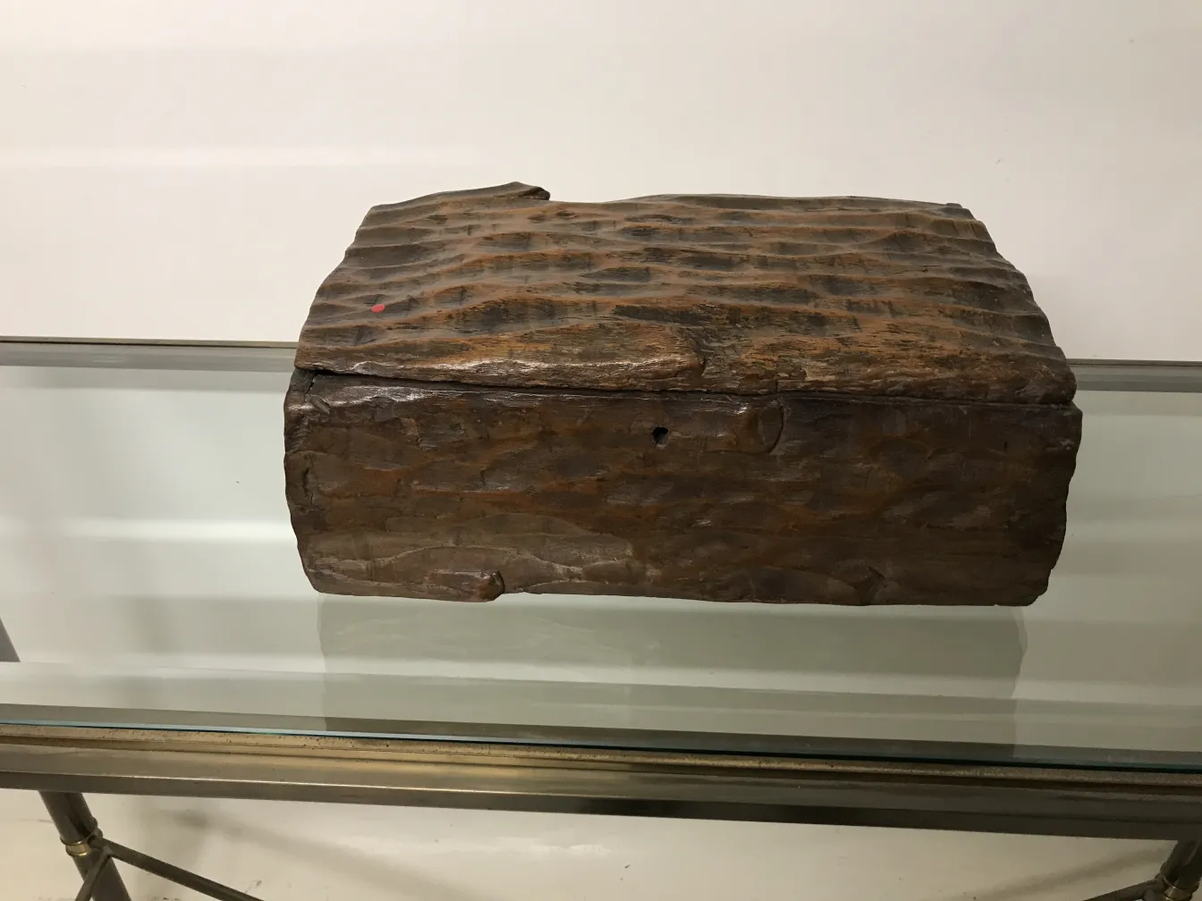 Antique wooden box with unique texture and rustic design.