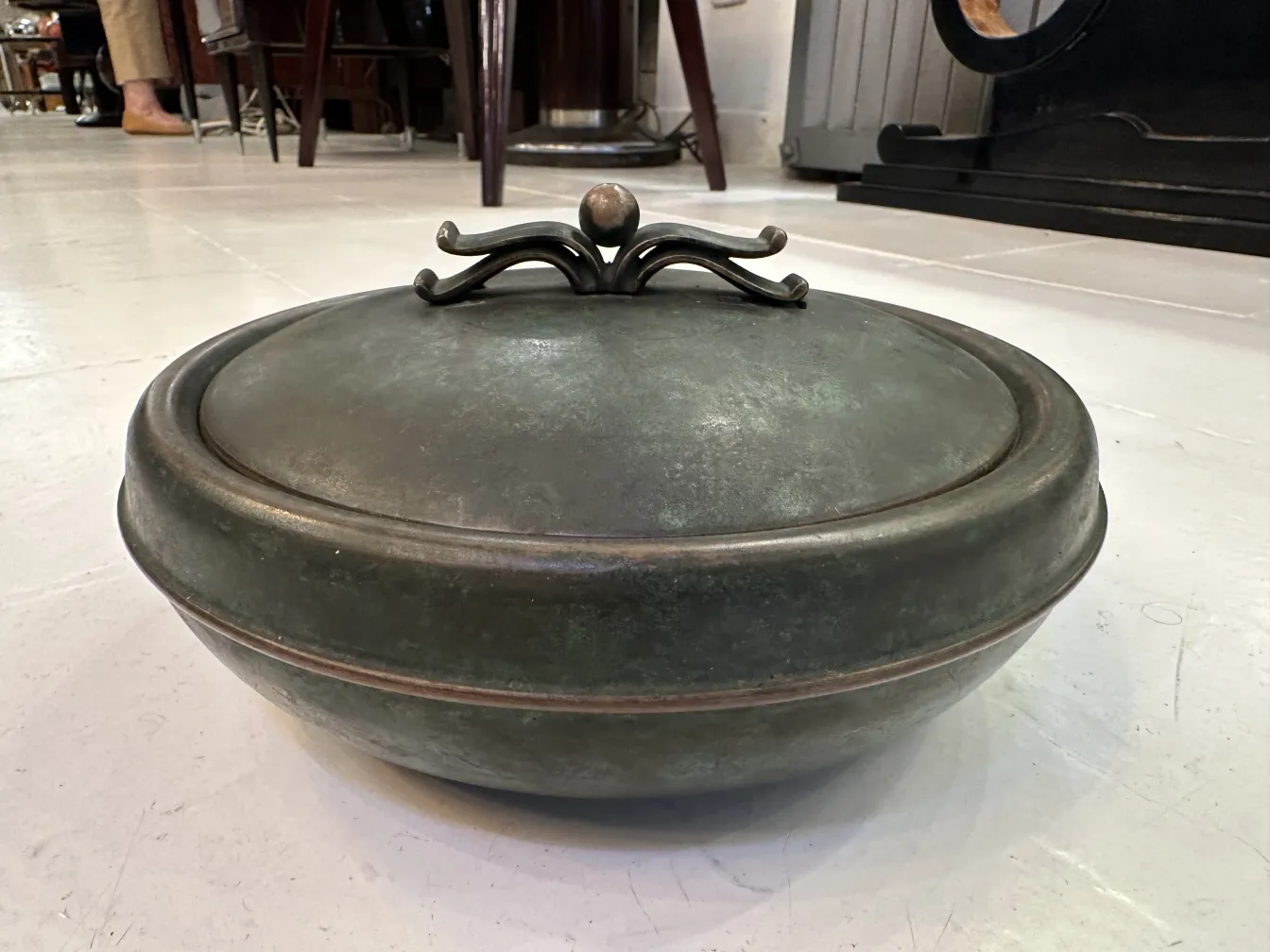 Antique decorative box with a classic design lid in a vintage setting.