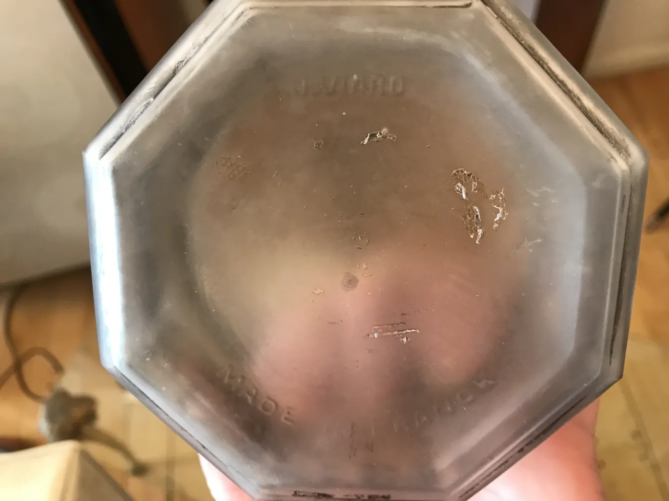 vista de la parte inferior de una caja antigua octagonal con detalles visibles