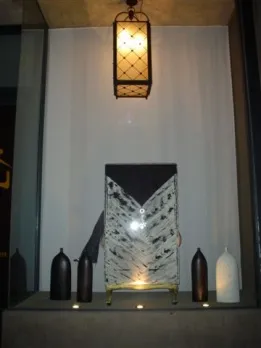 two antique hanging lanterns against a light background