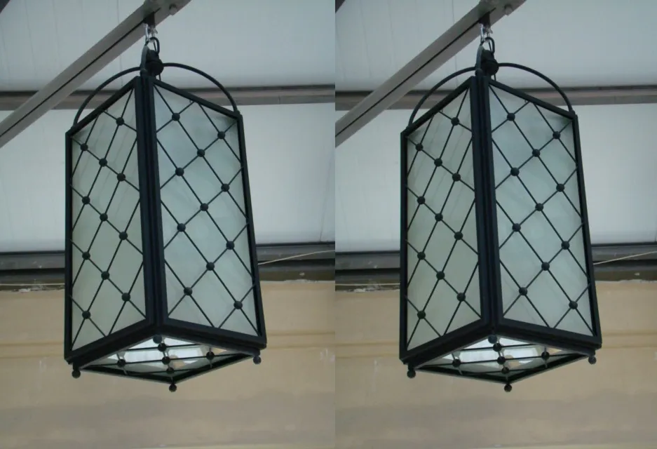 two antique metal hanging lanterns with soft light