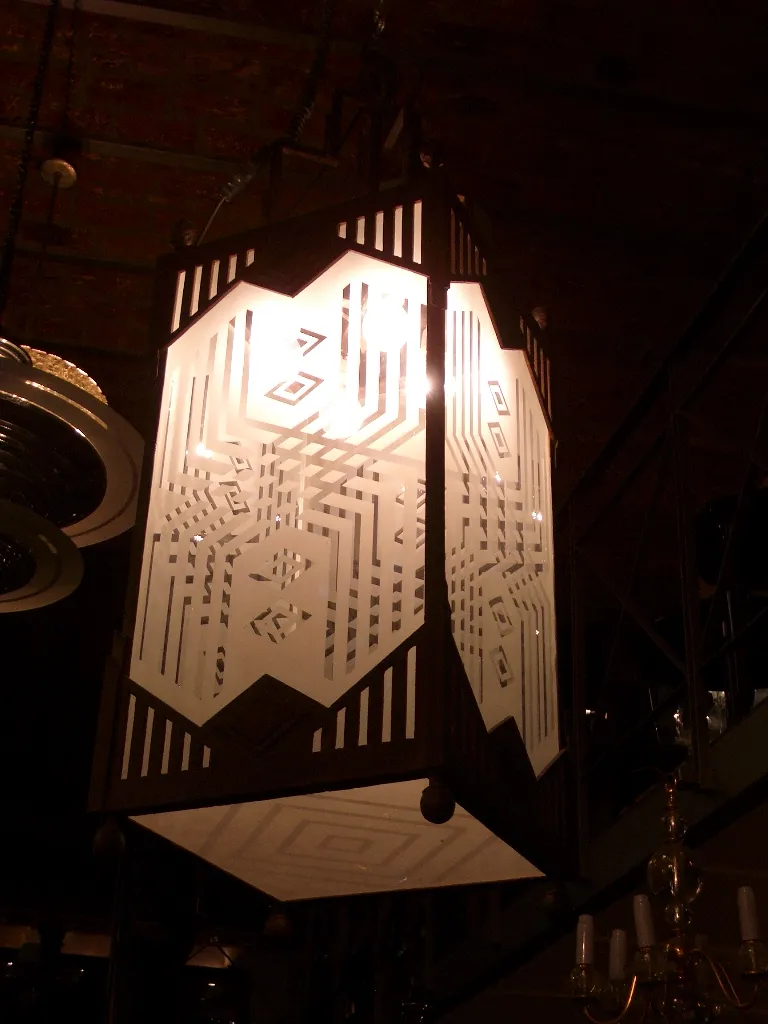 Two antique lanterns featuring a geometric design.