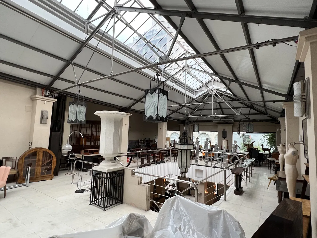 View of an antique space with 2 bright ceiling lanterns.