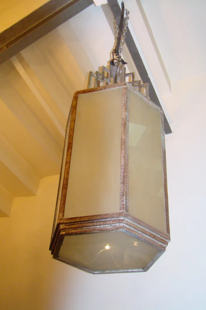 two antique hanging lanterns in a light room