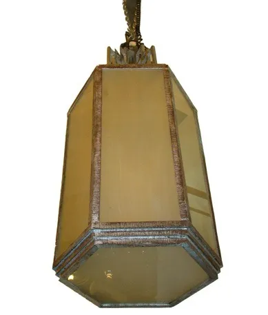 two antique hanging lanterns in a soft light setting