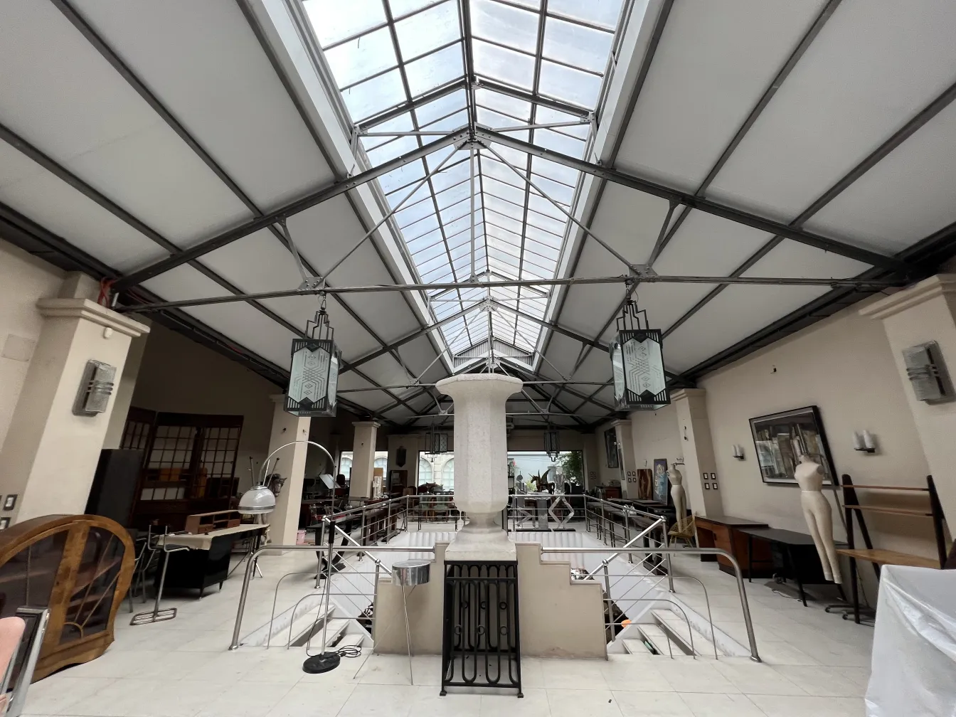 two antique lanterns hanging in an elegant interior space, illuminating the area with their classic design.