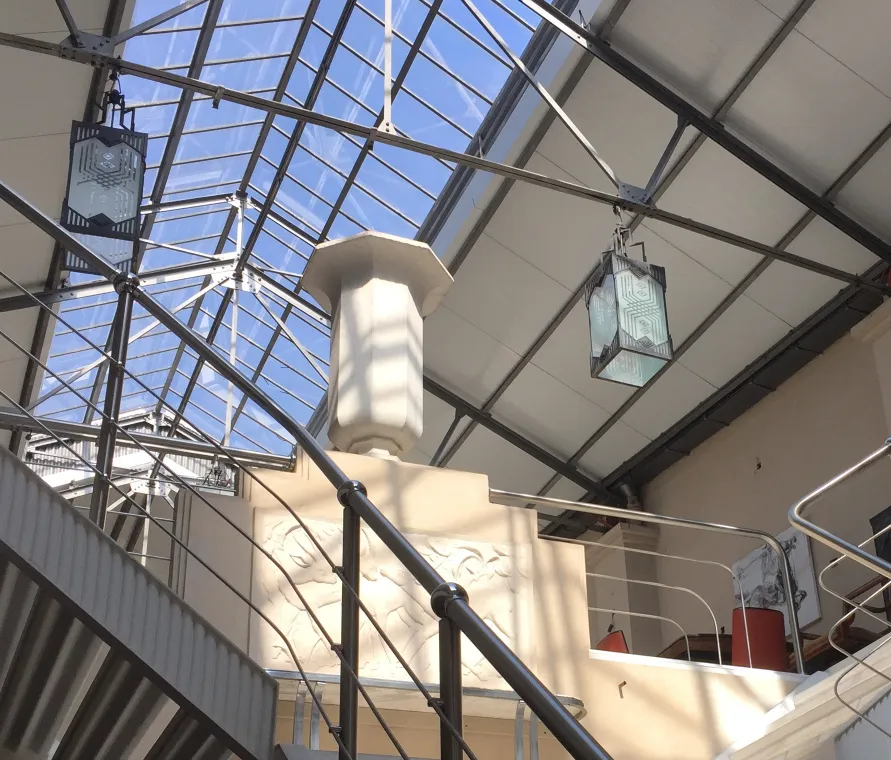 Two antique ceiling lanterns in a bright setting.