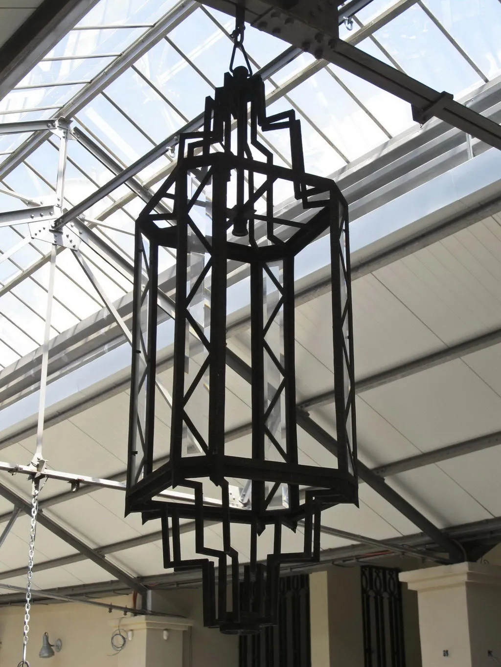 Two antique lanterns featuring a geometric design, hanging from the ceiling.