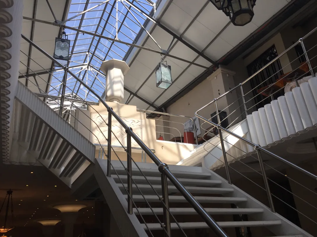 Duas farolas antigas penduradas em um interior amplo.