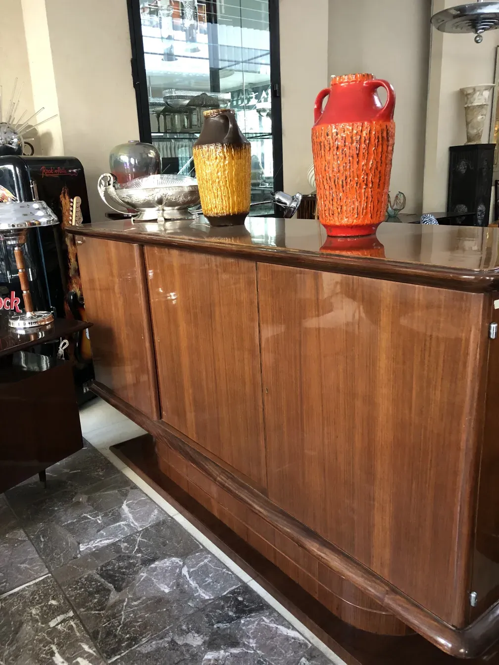 Antique sideboard with colorful ceramic vases on top