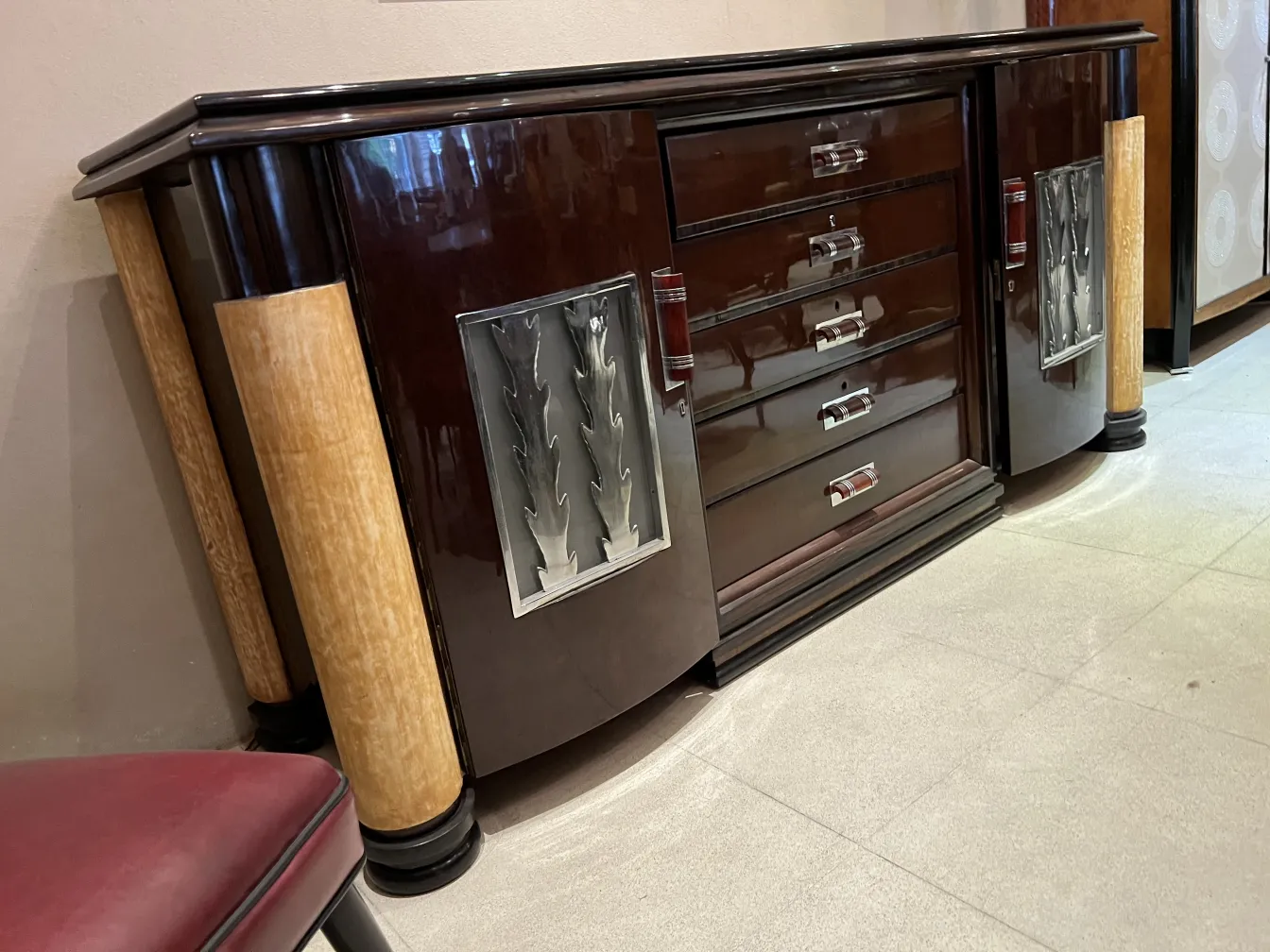 elegant antique sideboard with glossy finishes and decorative details, in a contemporary environment