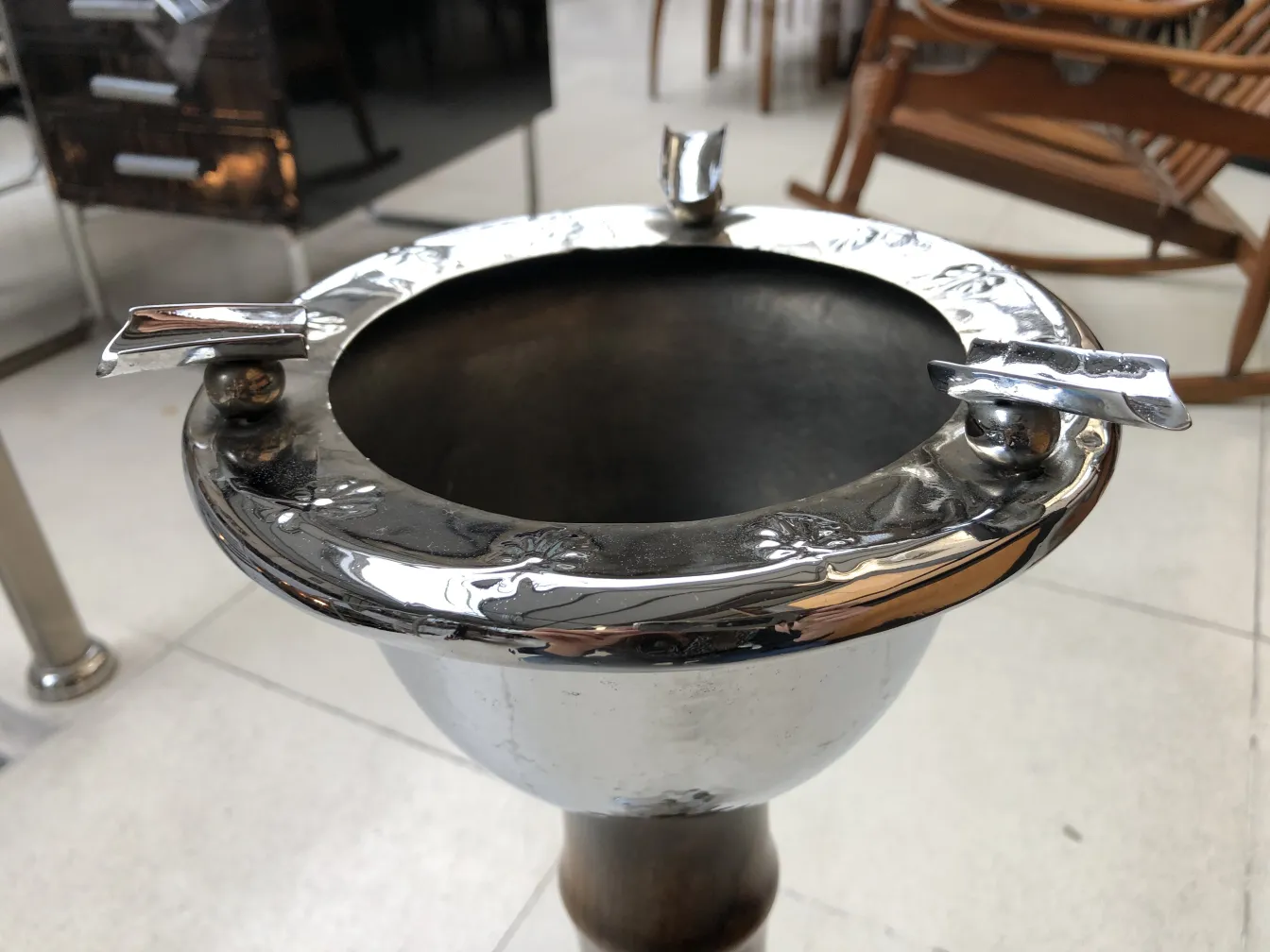 Antique standing ashtray, shiny with decorative details.