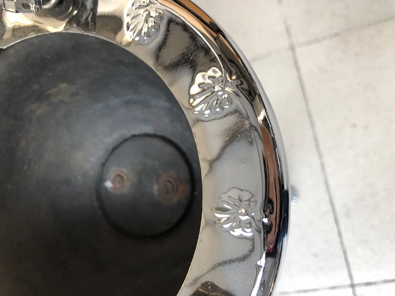 Antique standing ashtray with decorative details, classic setting.