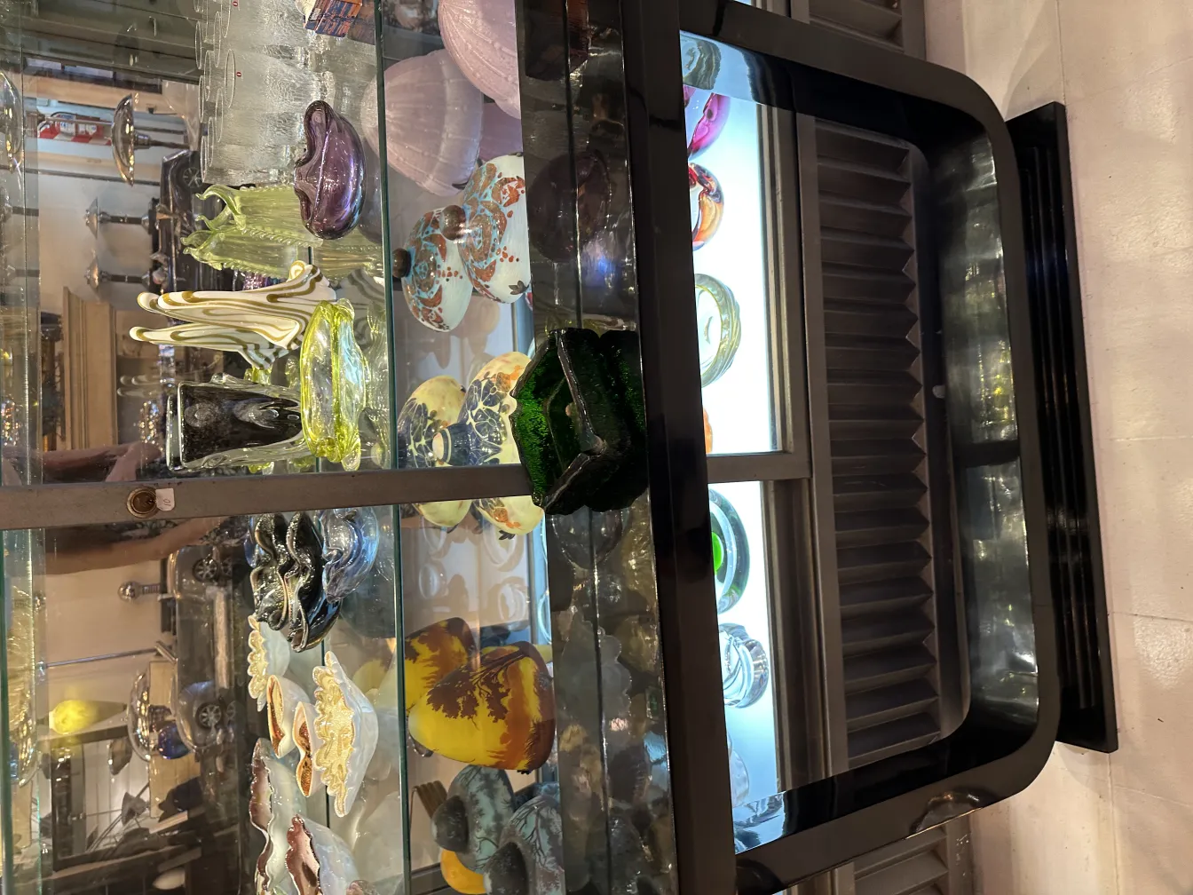 Standing ashtray in a mixed decorative antique setting, colorful design.