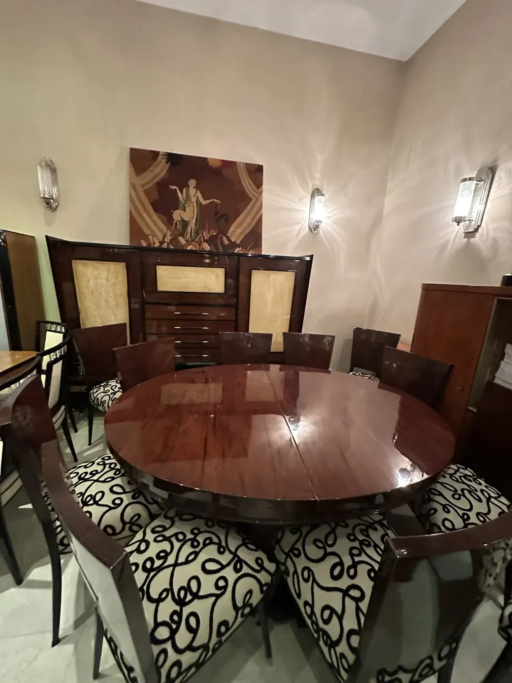 Antique bookcase in elegant setting with tables and chairs