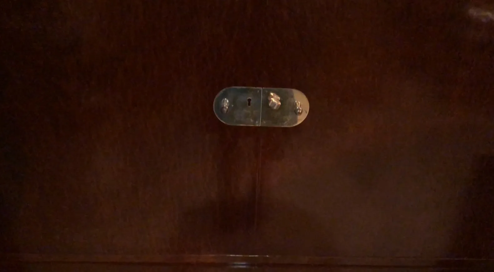 Antique wooden bookcase featuring a visible lock