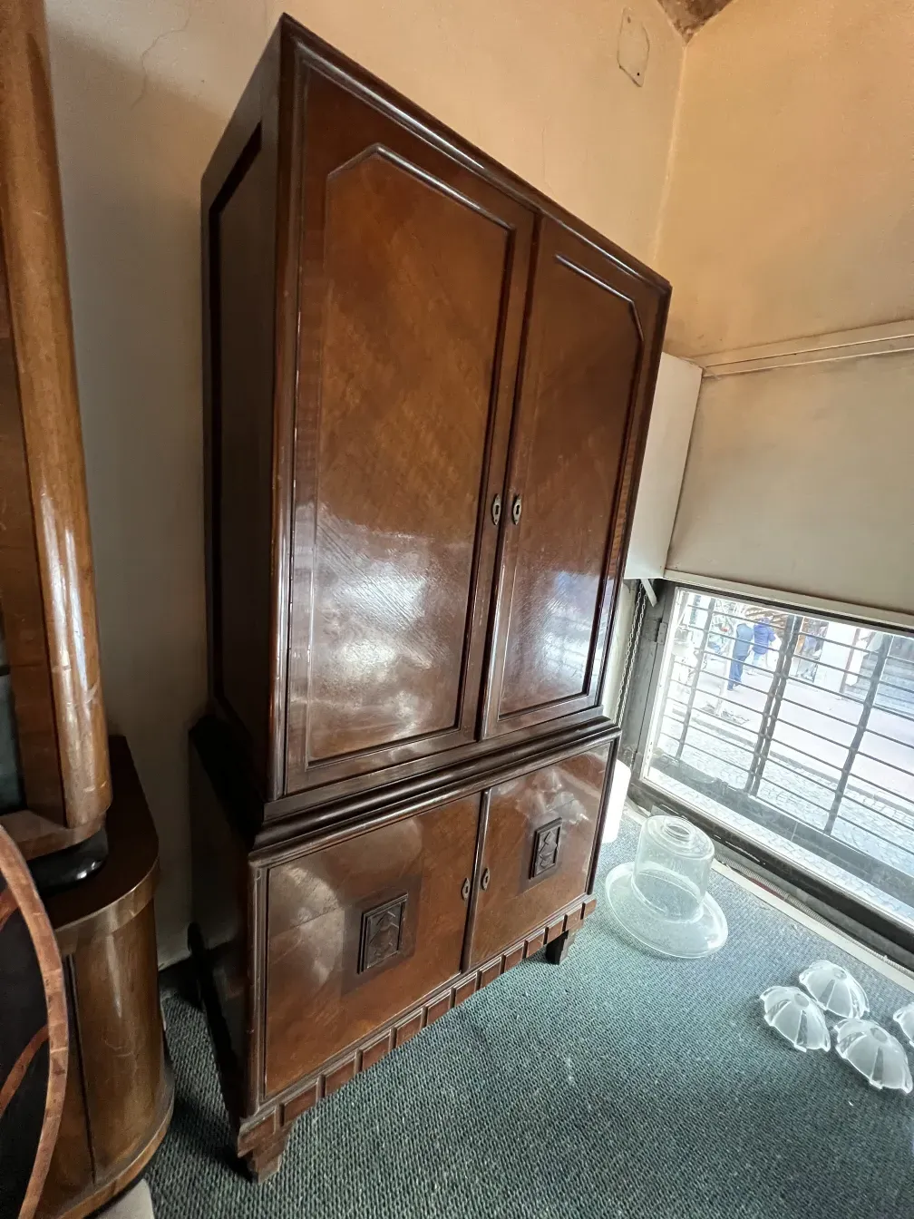 Antique bookcase with two cabinets and shelves. Cozy setting.