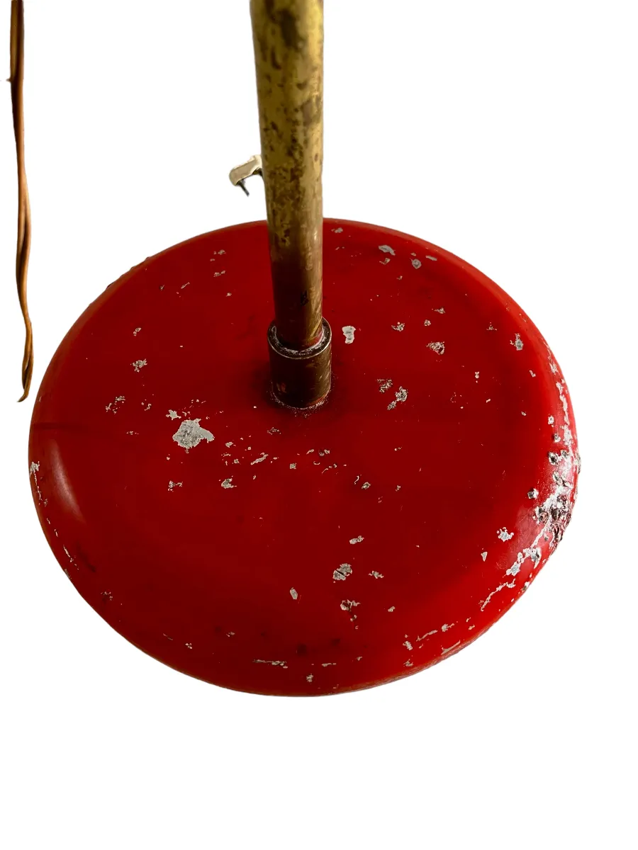 Antique floor lamp with a red base and worn details.
