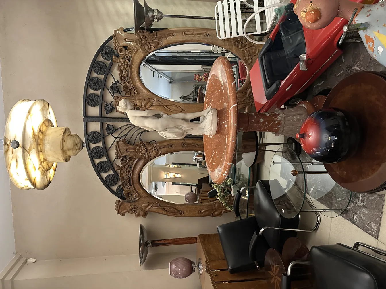 Antique floor lamp with elegant design and decorative base, set in a room with diverse decor.