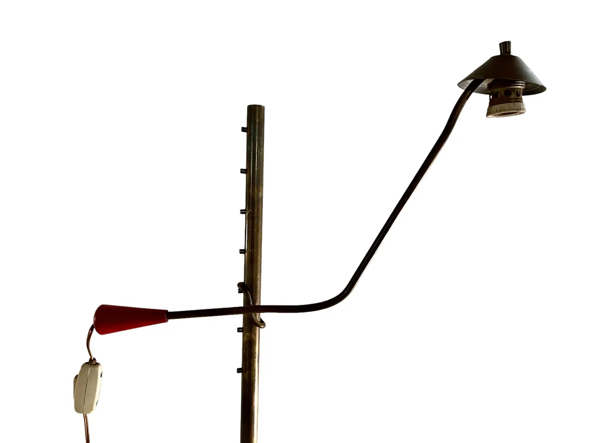 Antique floor lamp with curved design and red accents in a modern setting