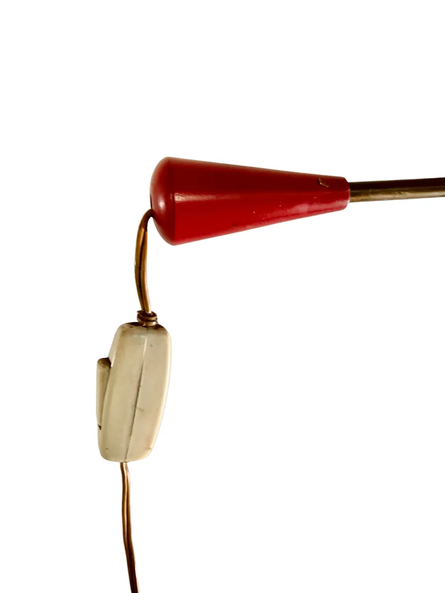 Antique floor lamp with red details and a switch.