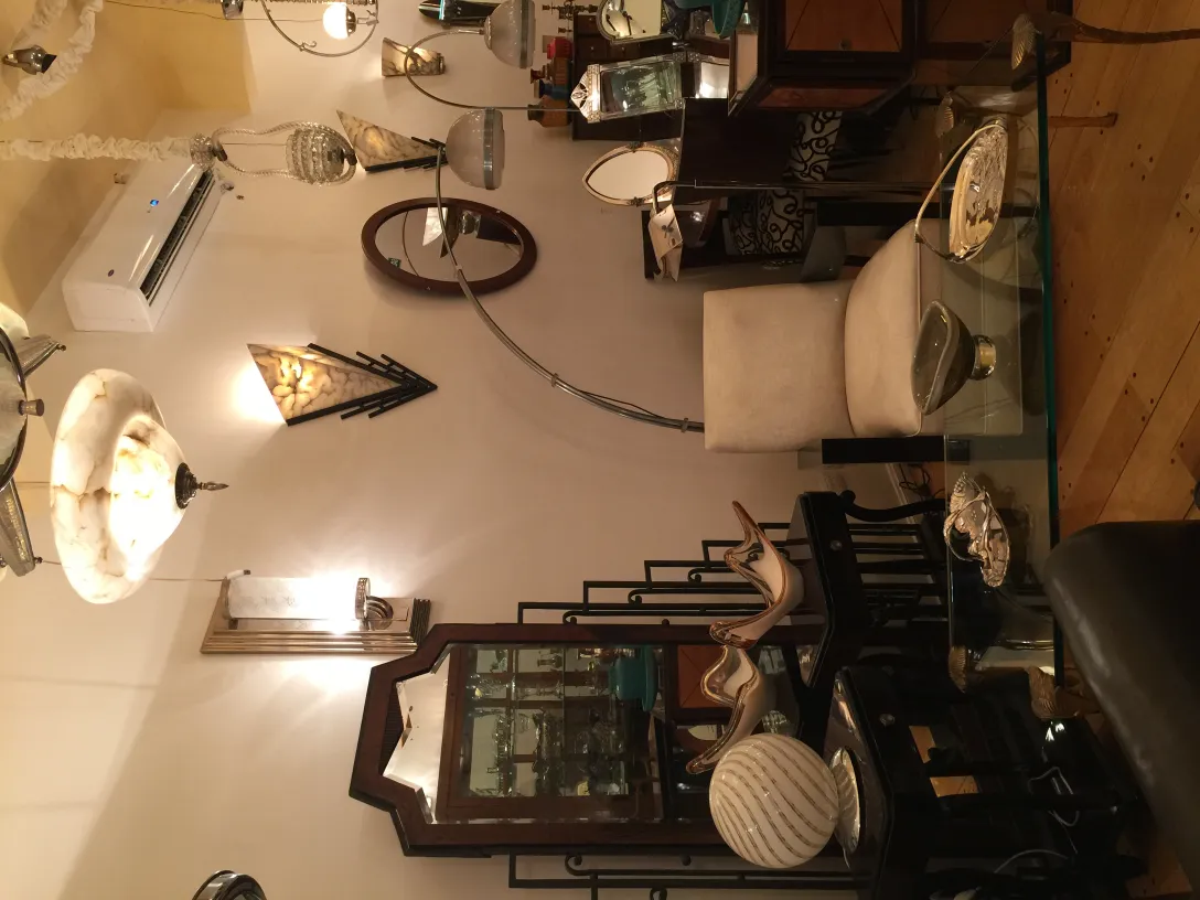 Antique floor lamp illuminating a cozy atmosphere, surrounded by elegant furniture.