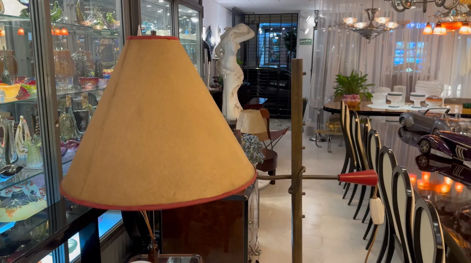 Antique floor lamp with cream shade, decorative and elegant, cozy atmosphere.