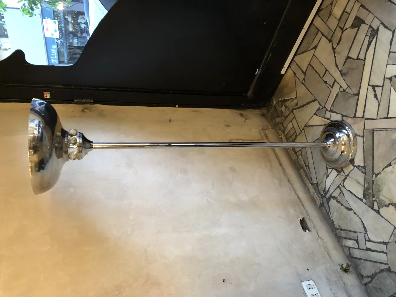 Vintage floor lamp with a shiny base, in a cozy setting.