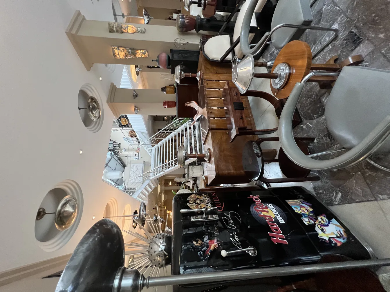 Antique floor lamp in an elegant setting, surrounded by chairs and tables.