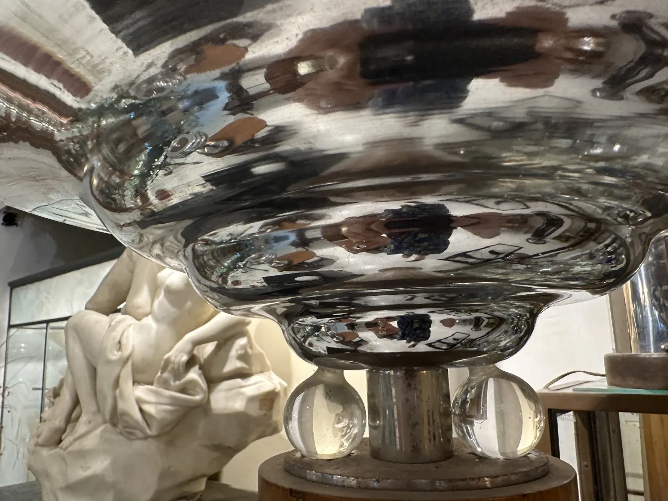 Antique floor lamp with shiny reflections and artistic ambiance.