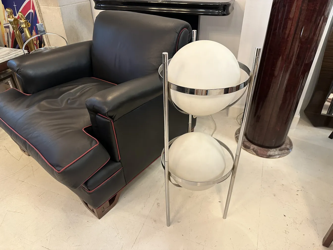 Antique floor lamp with two white spheres in an elegant stand.