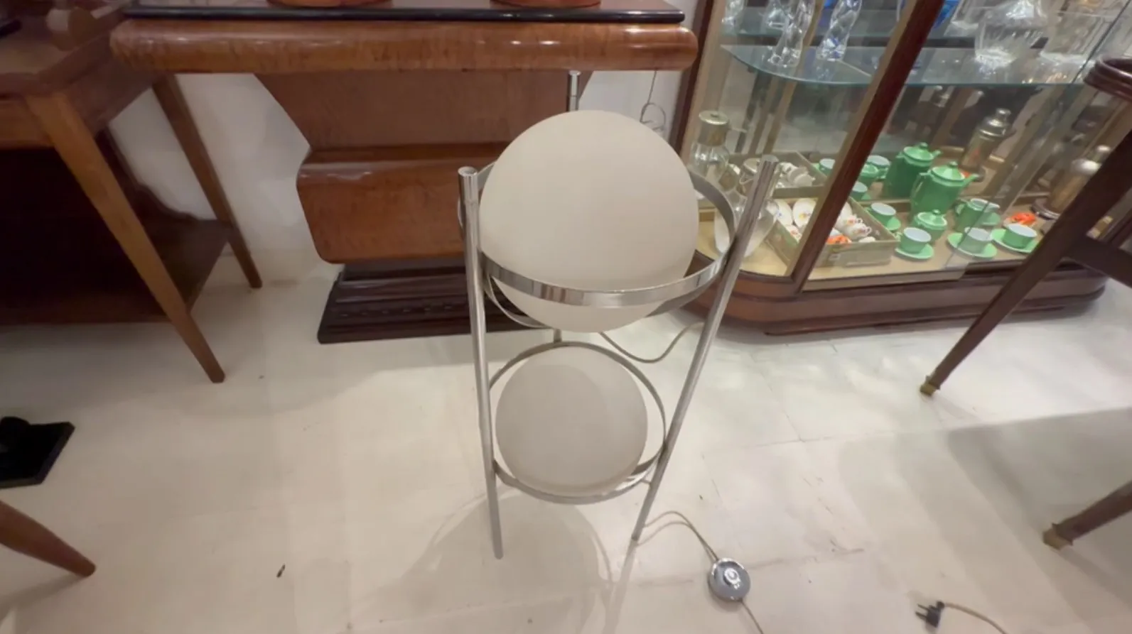 Antique floor lamp featuring two decorative globes in a stylish setting.