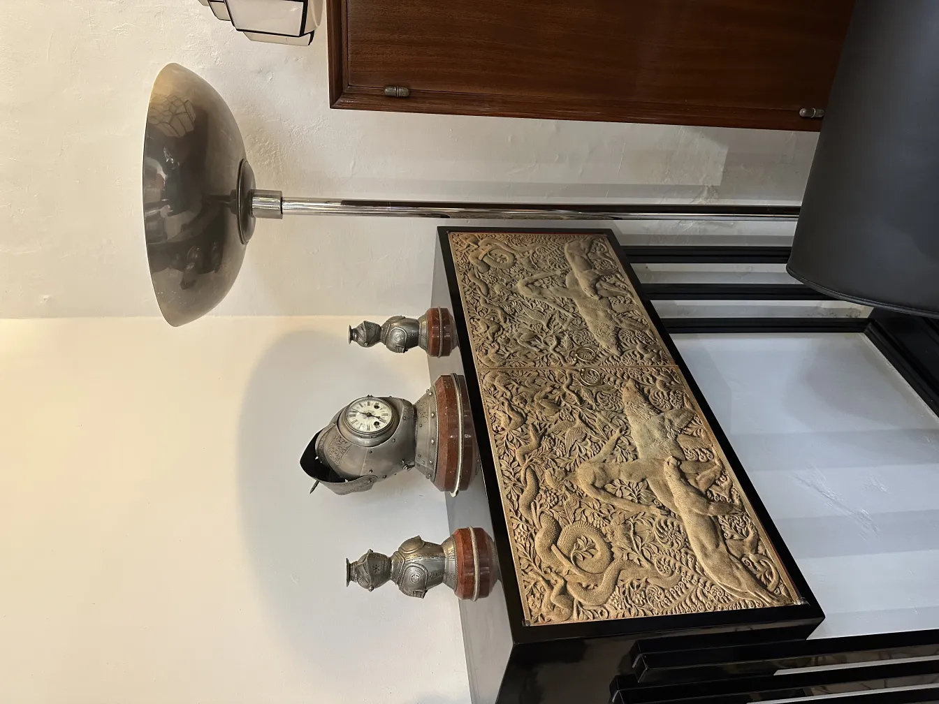 Antique floor lamp with a curved shade in a room setting.