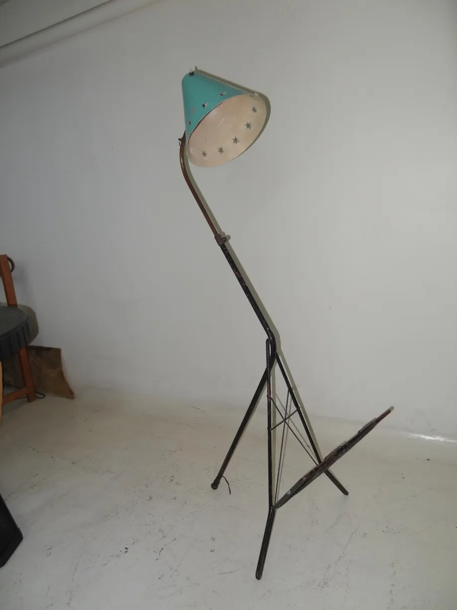 Antique floor lamp with a green shade and star cutouts.