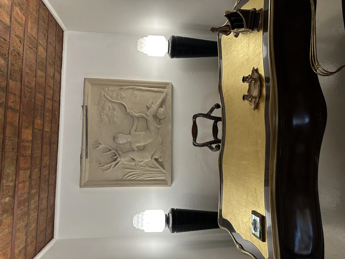 View of two illuminated antique floor lamps in a room