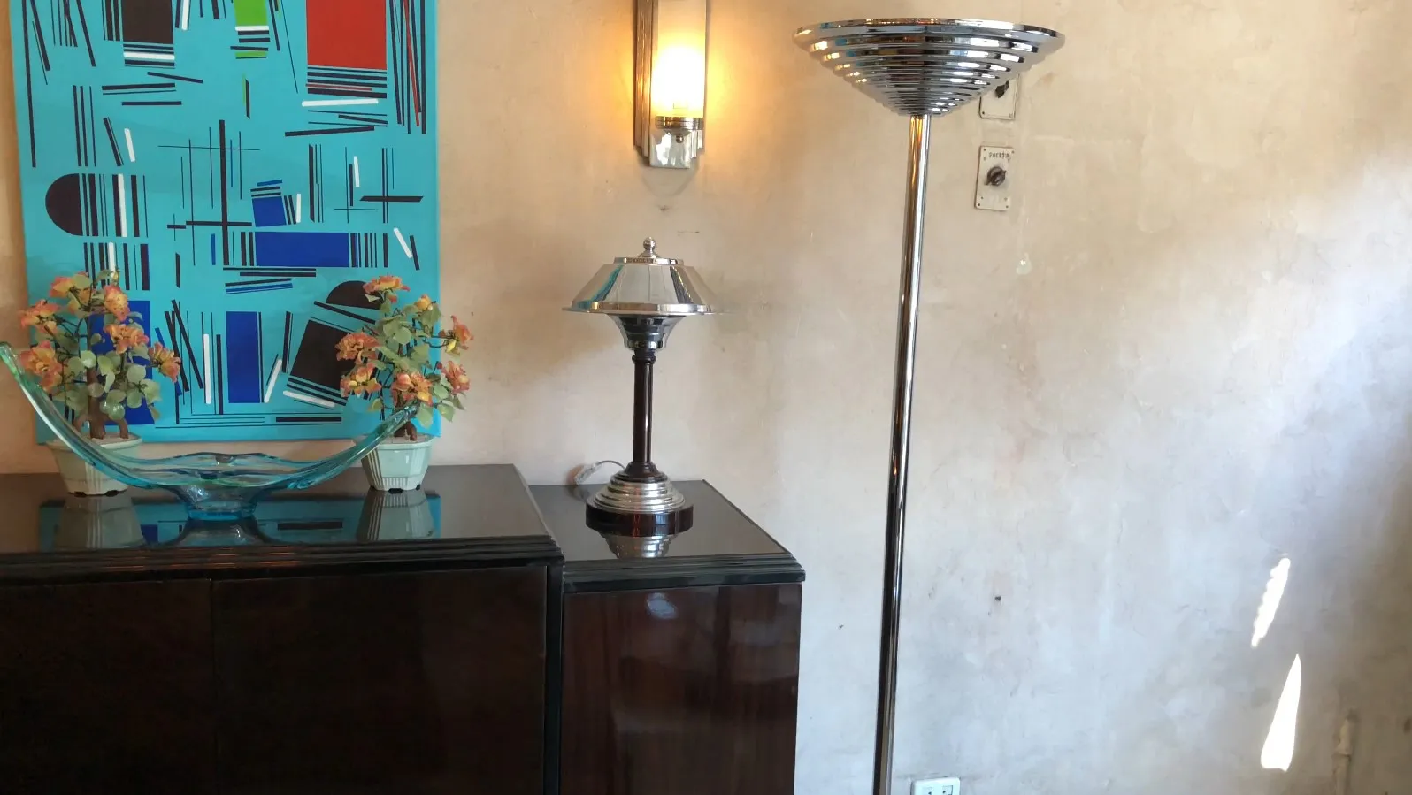 Two antique floor lamps in an elegant setting with colorful decor.