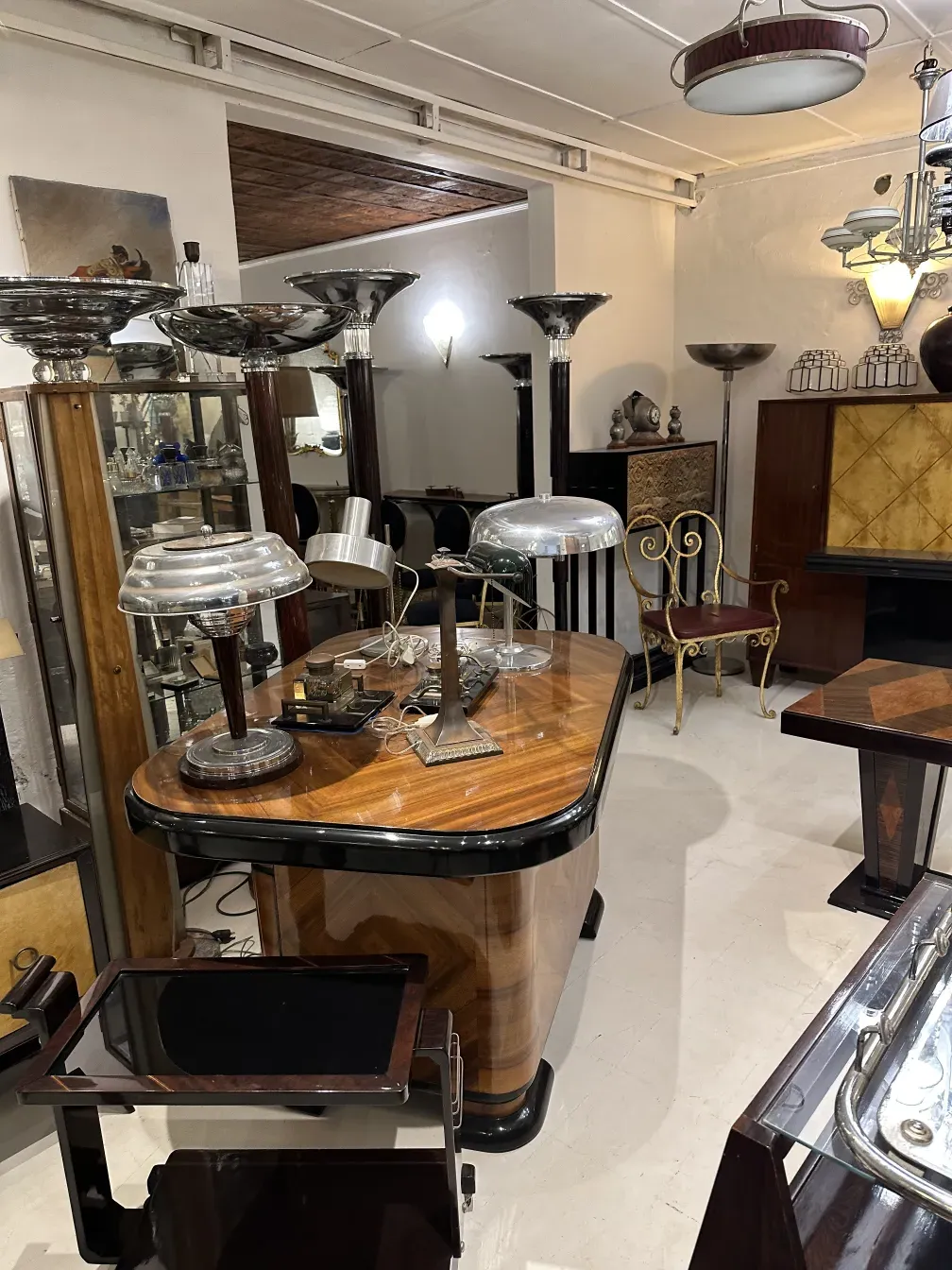 two antique floor lamps in an elegantly furnished room with decorative furniture