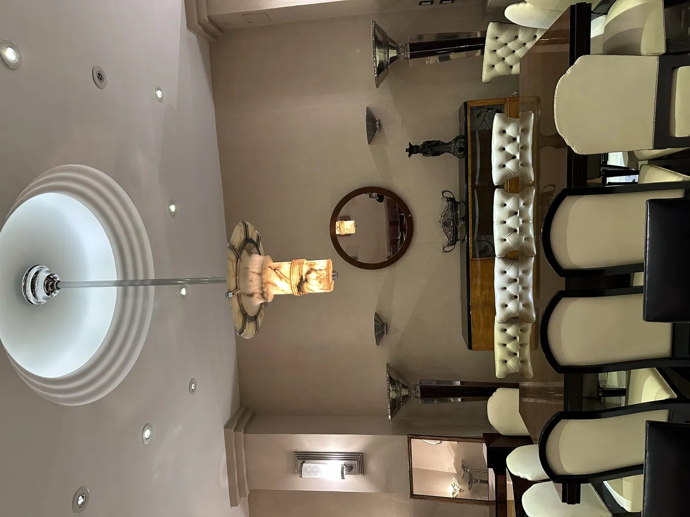 Two antique floor lamps in an elegant dining room setting.