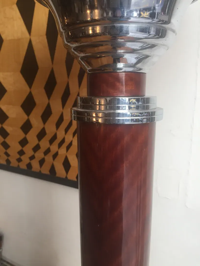 detail of 2 antique floor lamps with shiny base, in a cozy setting with geometric flooring