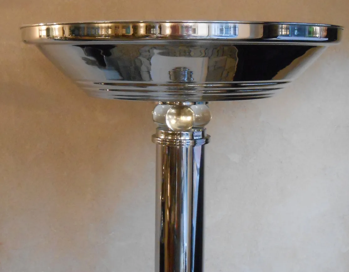 Detail of 2 vintage floor lamps with shiny base in an elegant setting.